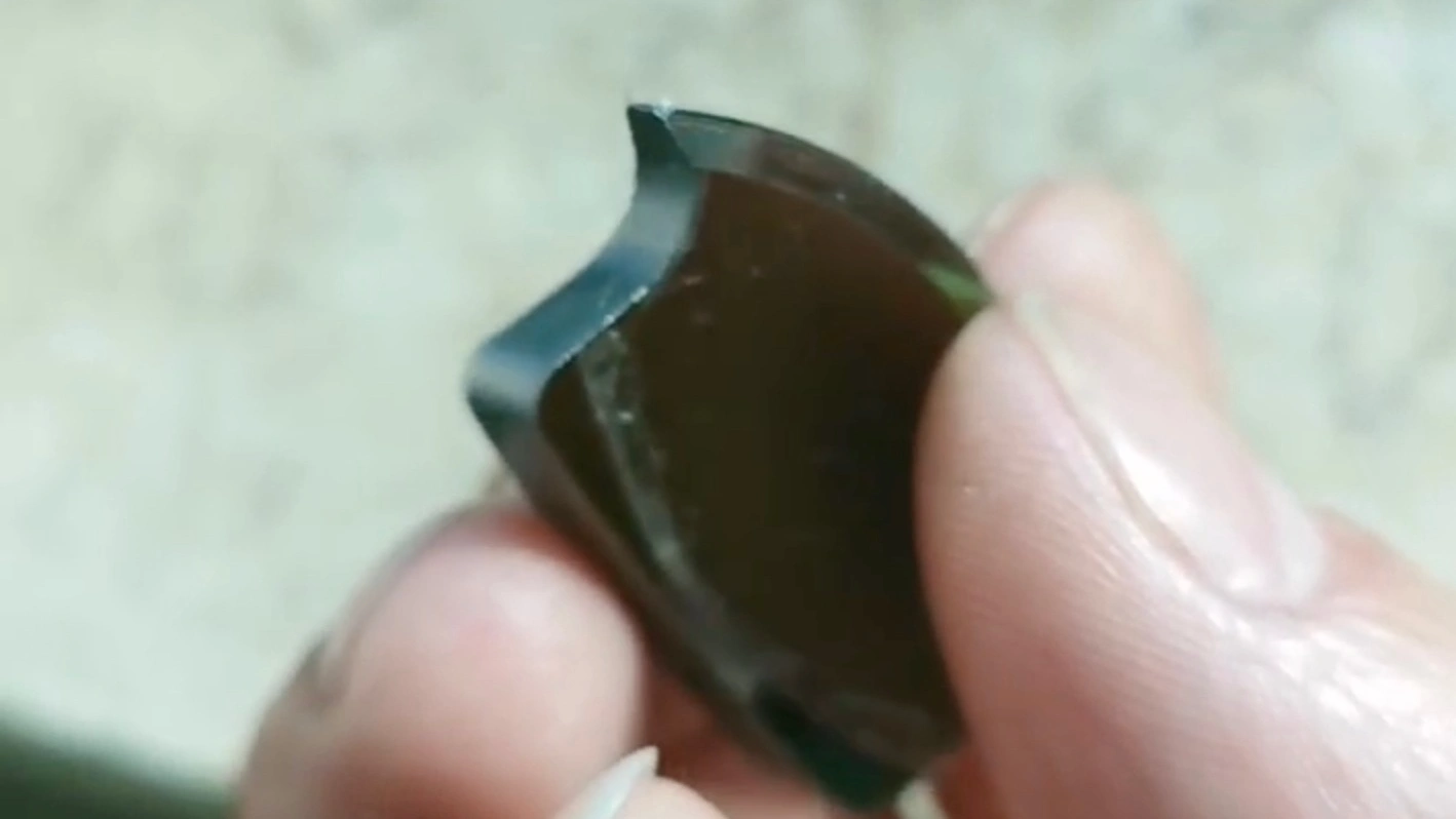 Cut crescent-shaped germanium lens blanks showing intact R corners and chip-free edges