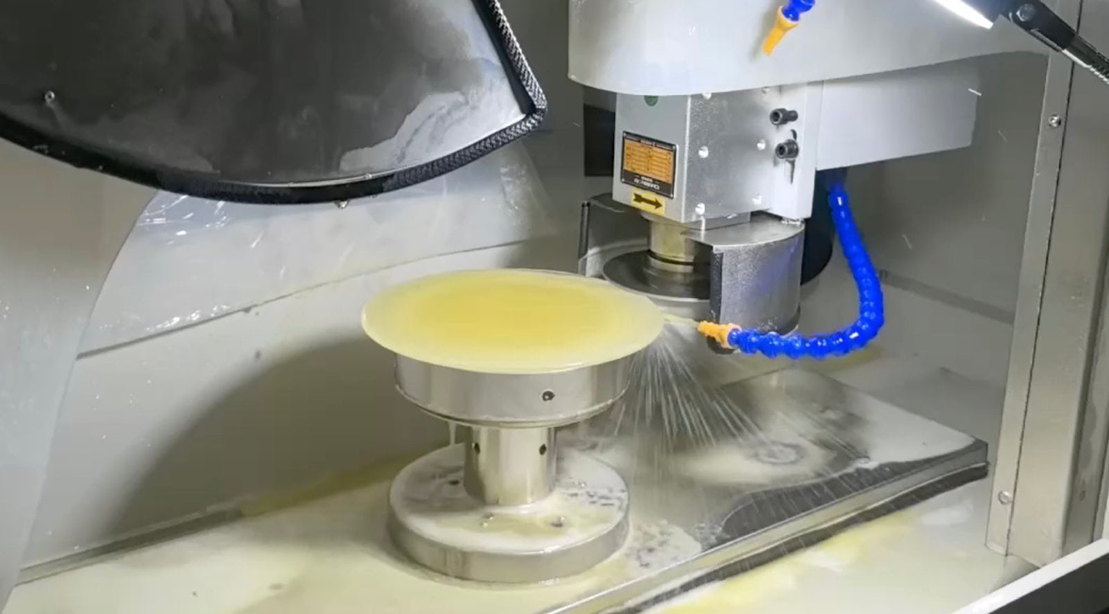 Large-aperture IR optics spherical grinding and chamfering in progress — the middle stations preserved during an IR optics cutting and polishing machine bookend upgrade on a Vimfun line