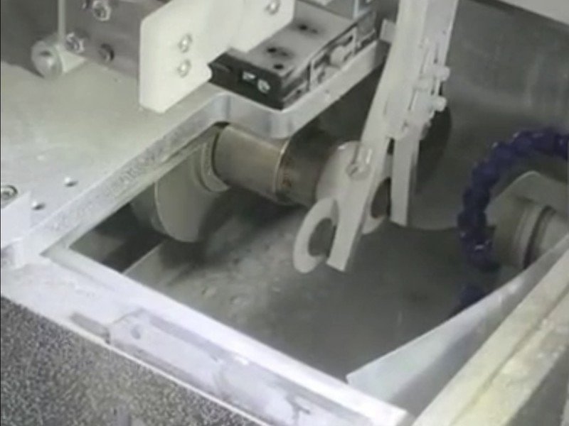 Enclosed wet machining chamber of the curve generator with cup wheel and vacuum chuck