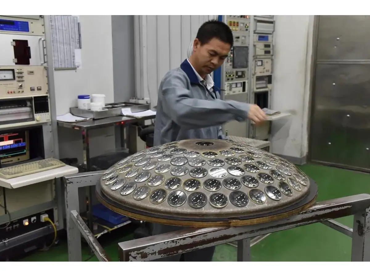 Operator handling a tray of optical components